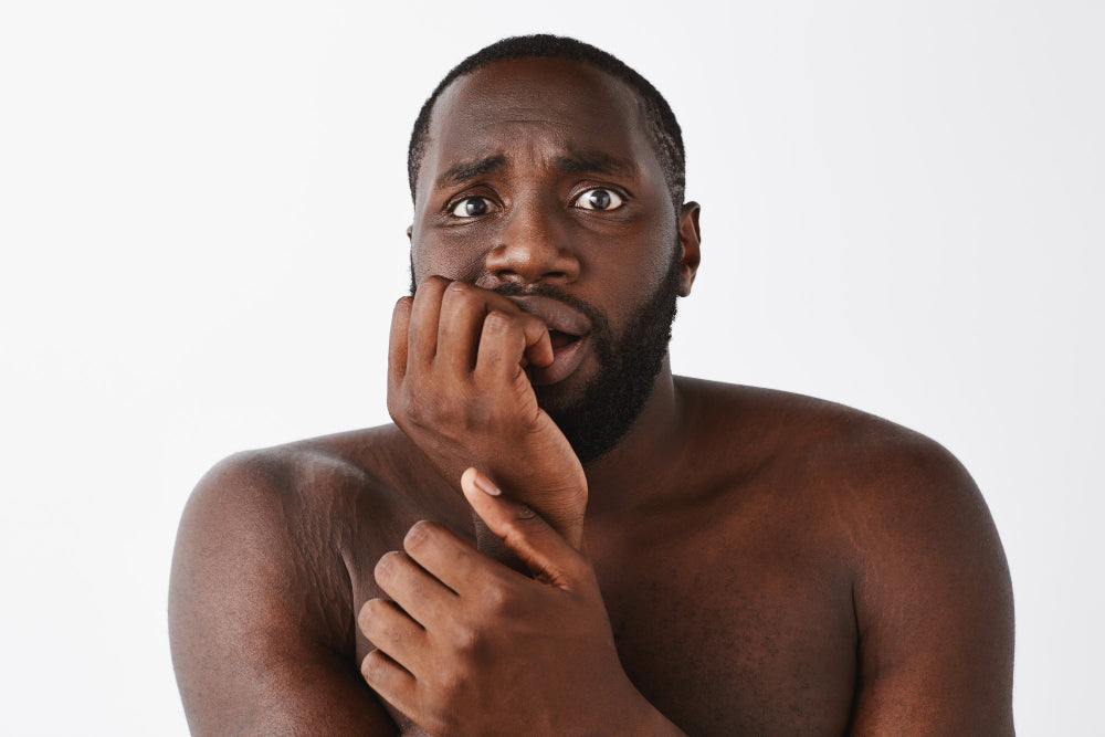 Conquering Hyperpigmentation: A Comprehensive Guide for Black and Brown Skin-scared youn black man - close up
